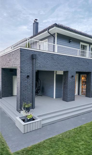 Grey composite deck with wide steps and a matching planter