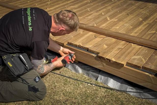 Screwing down timber deck boards, close-up